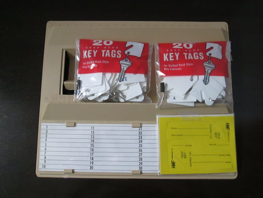A beige-colored, molded plastic key file rack with numbered slotted key tags and 'Out Key' tags, designed to hold 40 keys.