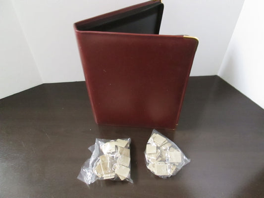 A burgundy vinyl key case with a heavy duty zipper, designed to hold 48 key tags, displayed with the key tags visible in an open condition.